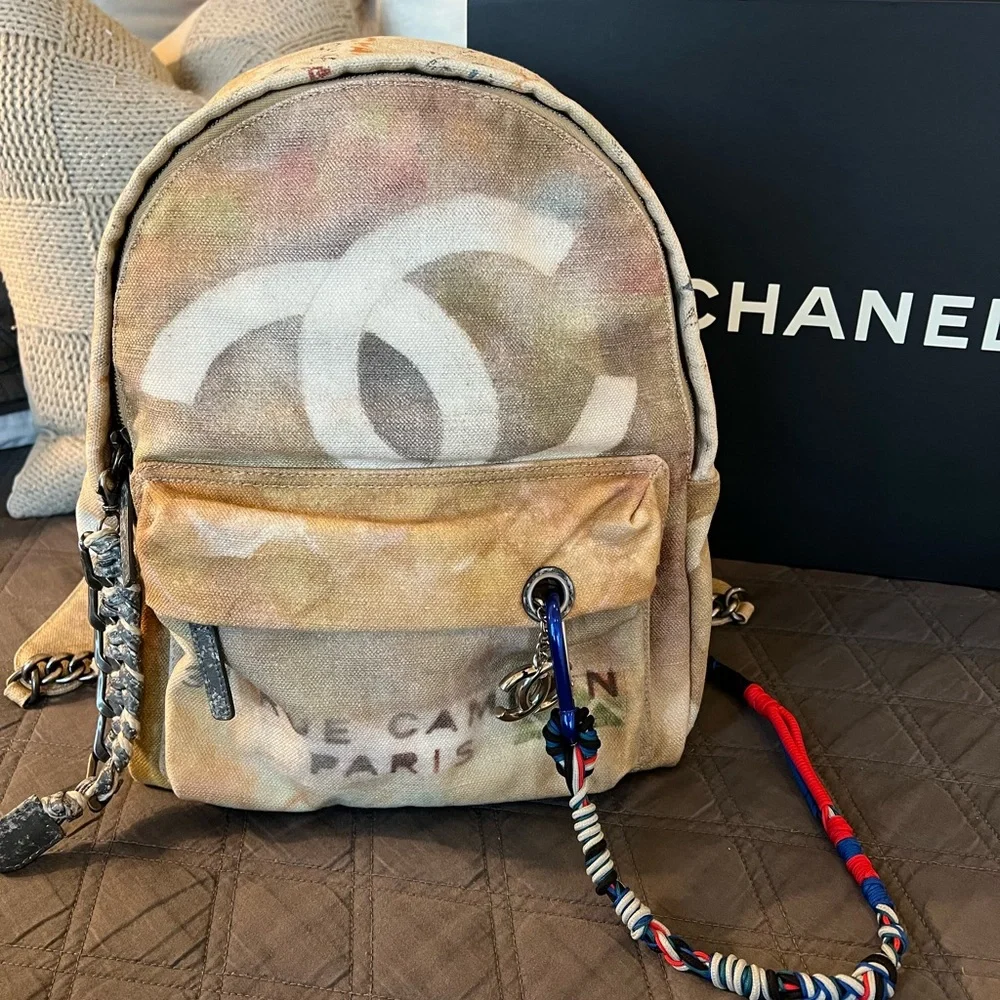 CHANEL Faded Beige Canvas Backpack with Multicolor Strap and Silver-Tone Charm Chanel Beige Multicolor Canvas Backpack Multiple colors  main image 3